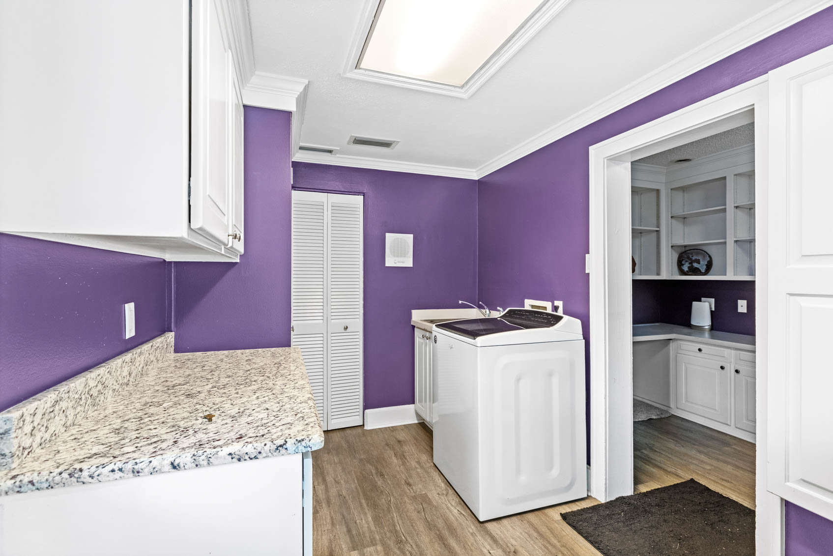 laundry room with purple walls
